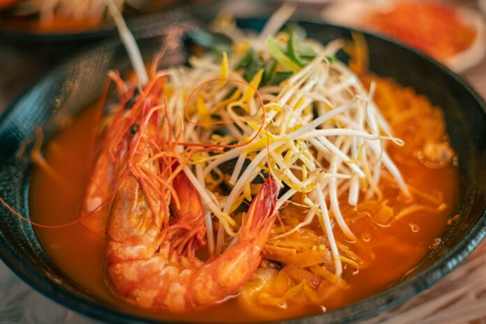 a close up of a bowl of food with shrimp