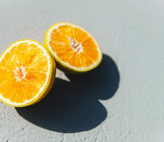 비타민과 미네랄이 풍부한 식단으로 면역력 강화하기 two oranges cut in half sitting on a table