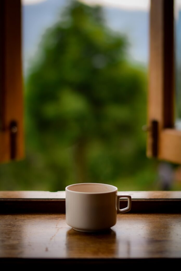 Photo by Maheima Kapur white ceramic mug on brown wooden table