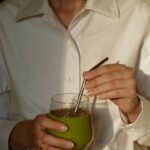 몸과 마음을 챙기는 생활, 진화하는 웰니스 문화가 뜬다 person in white button up shirt holding clear drinking glass with green liquid